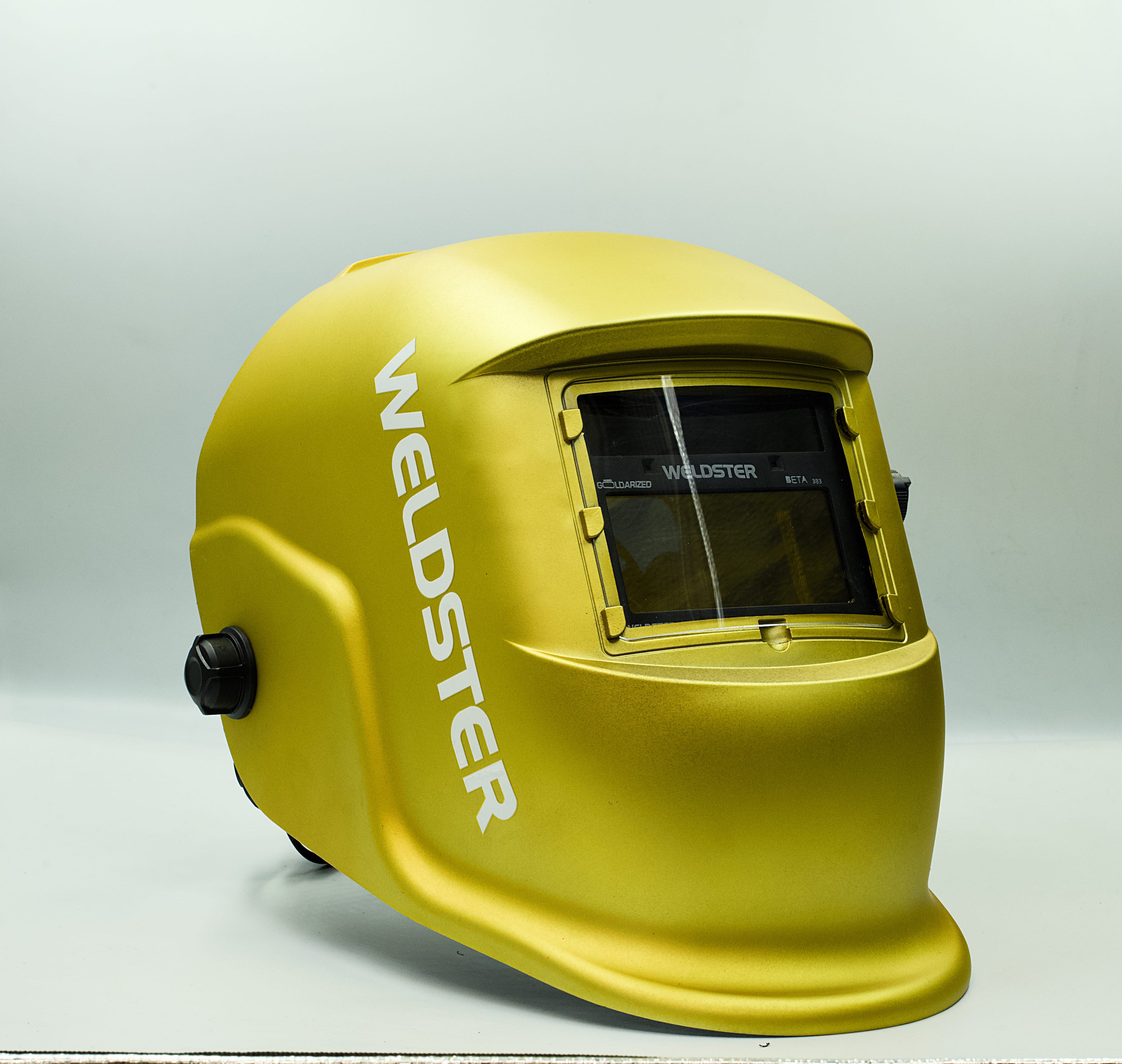 Careta de soldar WELDSTER Goldarized dorada, vista lateral con el filtro fotosensible